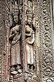 Ta Prohm temple - devatas sculpted on the gallery walls 